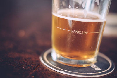 Close-up of beer served on table