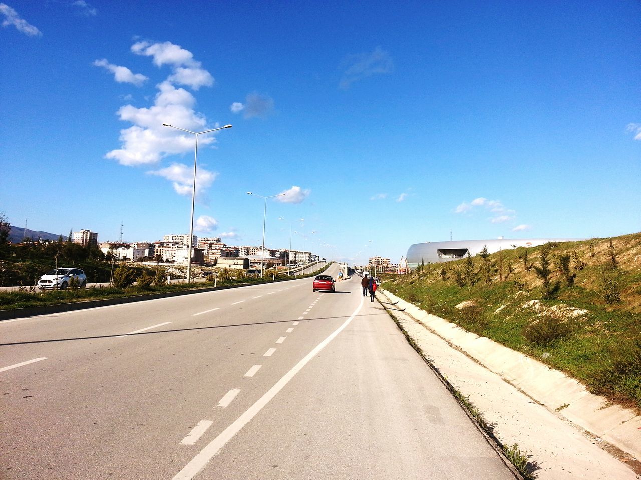 transportation, land vehicle, road, mode of transport, the way forward, car, sky, blue, road marking, vanishing point, diminishing perspective, street, on the move, day, country road, travel, landscape, cloud, sunlight, cloud - sky