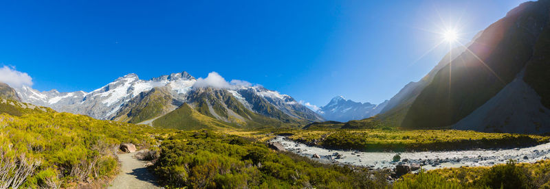 Scenic view of snowcapped mountains against clear blue sky