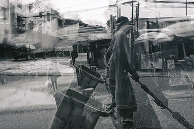People working on bridge in city