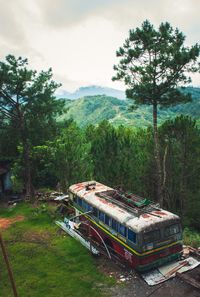 Abandoned truck on field against sky