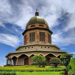 Low angle view of building against cloudy sky