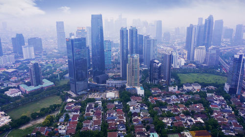 High angle view of modern buildings in city against sky