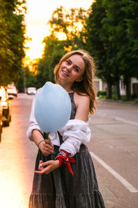 Portrait of a smiling young woman standing outdoors