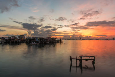 Pier at harbor during sunset