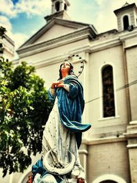 Low angle view of statue against building