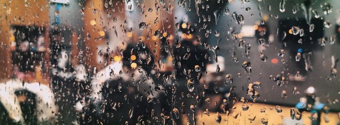 Full frame shot of wet glass window in rainy season