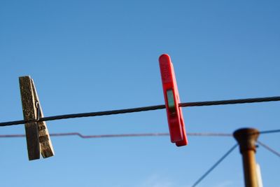Low angle view of pole against clear blue sky