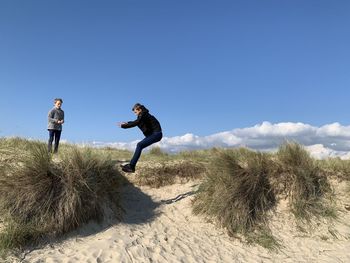 People on land against sky