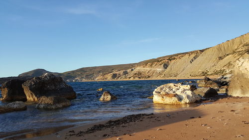 Scenic view of sea and mountains against sky