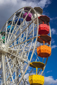 Low angle view of ferris wheel against sky