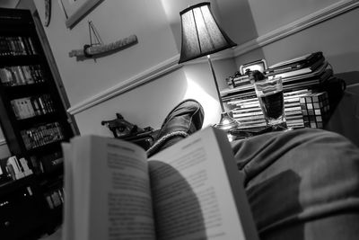 Low section of man with book at home