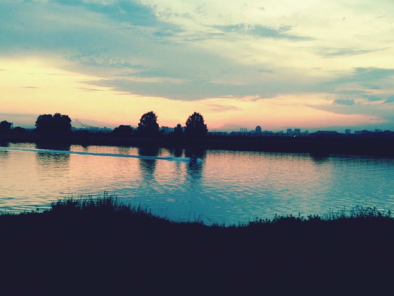 sunset, silhouette, water, sky, tranquil scene, scenics, reflection, tranquility, lake, beauty in nature, nature, cloud - sky, idyllic, cloud, waterfront, dusk, tree, river, calm, outdoors