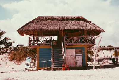 Built structure on beach against sky