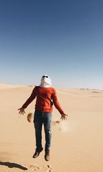 Full length of man on sand dune