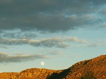 Scenic view of mountains against cloudy sky