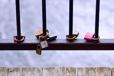 Close-up of rusty padlock on railing