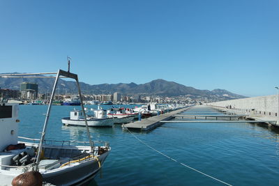 Boats moored at harbor