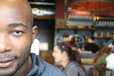 Portrait of young man looking away at restaurant