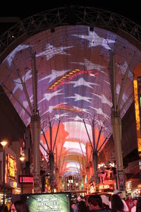 Low angle view of illuminated ferris wheel at night