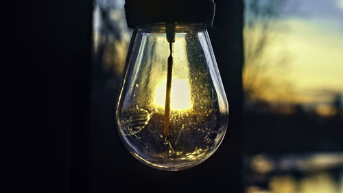 Close-up of light bulb on table