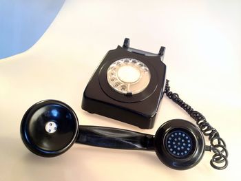 Close-up of rotary telephone on table