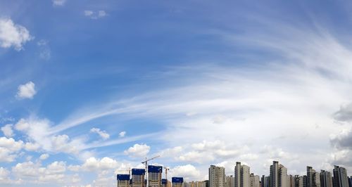 Low angle view of buildings against blue sky