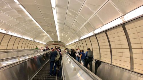 People walking on escalator