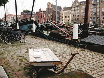 Bicycle parked on footpath by buildings in city