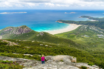 Scenic view of sea by mountains against sky