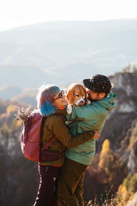 Rear view of couple standing against sky