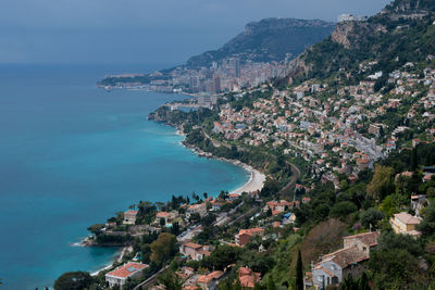 High angle view of townscape by sea against sky