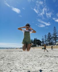 Woman jumping on beach