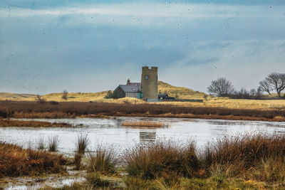 A small castle like building by a pond