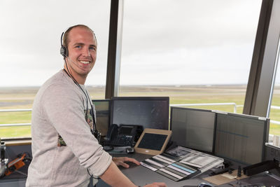 Cheerful flight operations officer during work