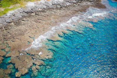 High angle view of rocks in sea