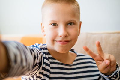 Teen boy takes selfie and loves blogging on social media in living room