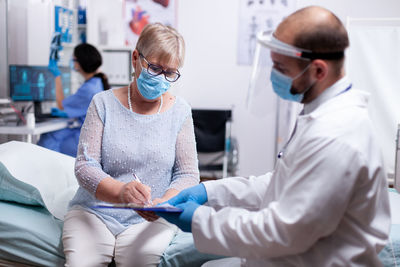 Female doctor examining patient at clinic