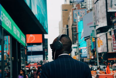 Rear view of man standing in city