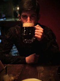 Portrait of a young man drinking glass