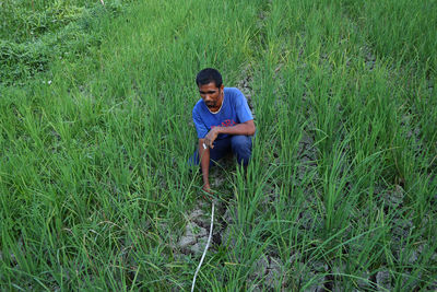 Full length of young man on field