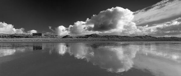 Scenic view of sea against cloudy sky