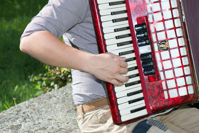 Midsection of man playing piano