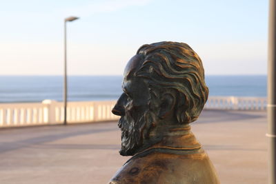 Close-up of statue against sea