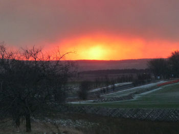 Scenic view of field against sky during sunset