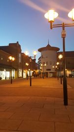 Illuminated street light against sky at night