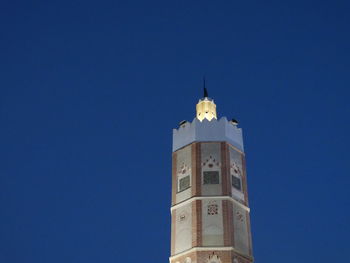 Low angle view of tower against blue sky