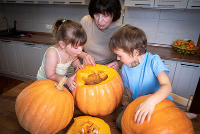 High angle view of boy with pumpkin