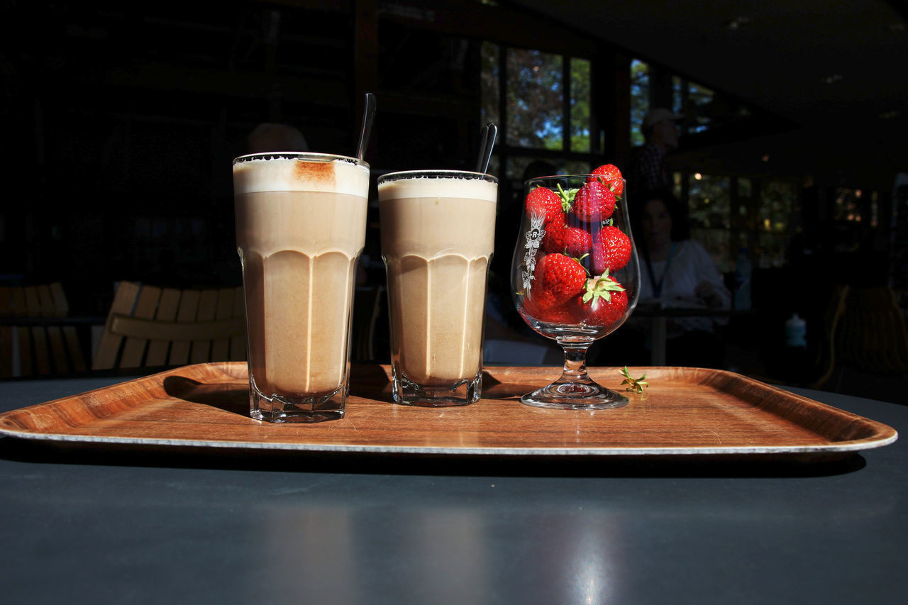 CLOSE-UP OF DRINK ON TABLE WITH GLASS OF JUICE