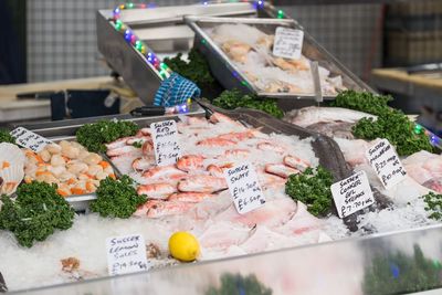 High angle view of fresh seafood with labels at market stall